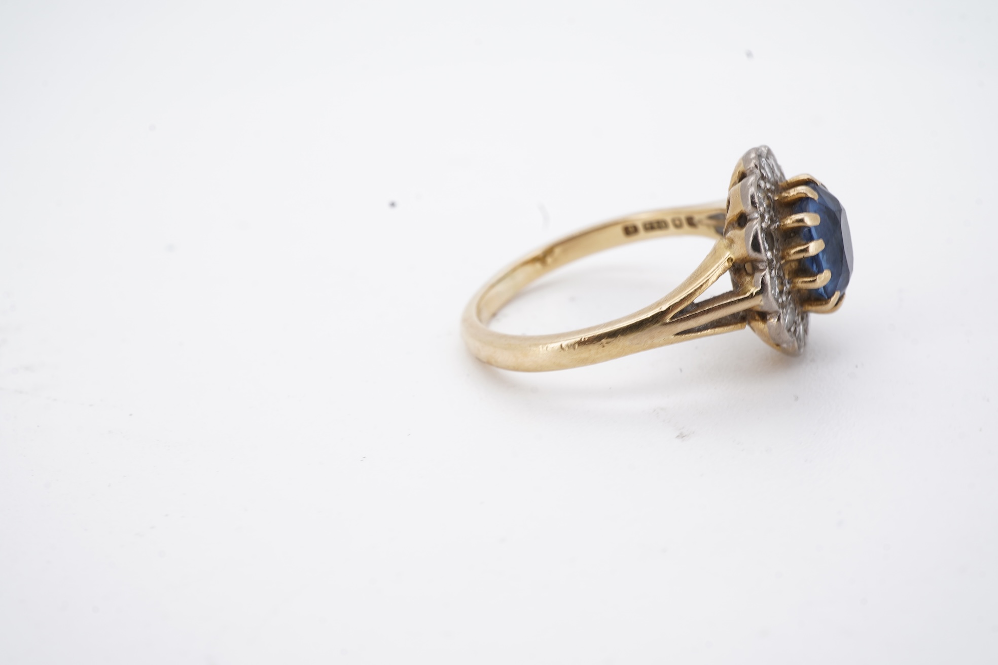 A 1980's 18ct gold, sapphire and diamond set oval cluster ring, size K, gross weight 3.8 grams.
